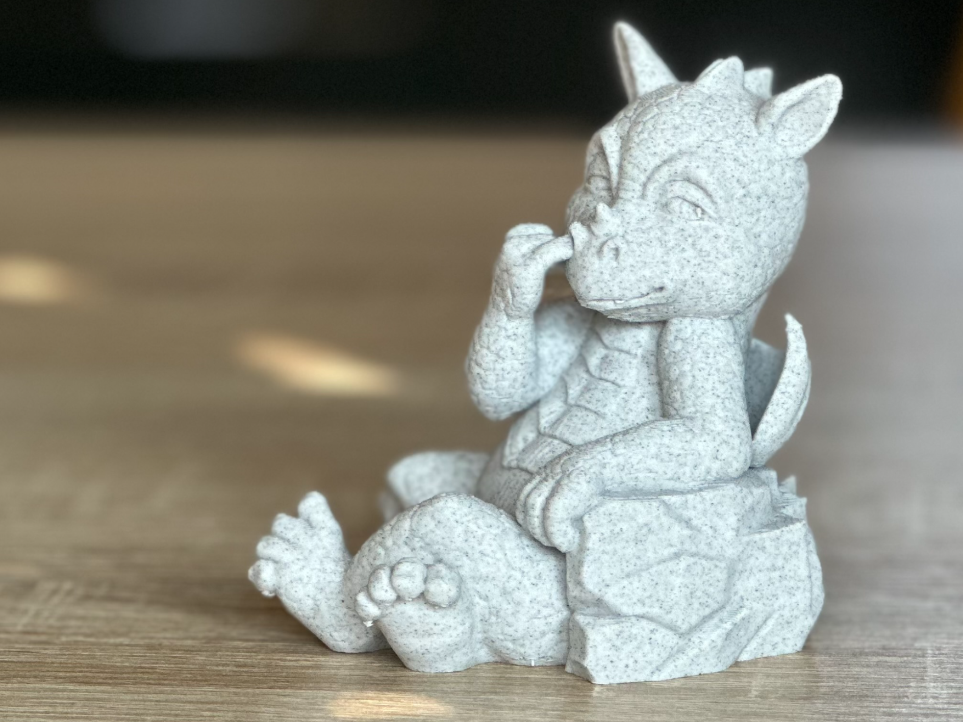 Statue of a dragon picking its nose
