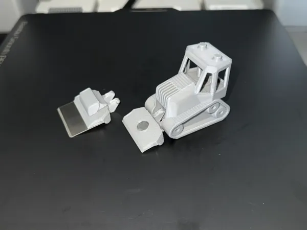 Racloir bulldozer pour plateau d'impression