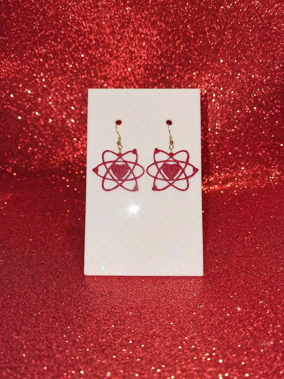 Heart in atom earrings view 2