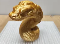 Figurine tête de serpent dorée — photo 2