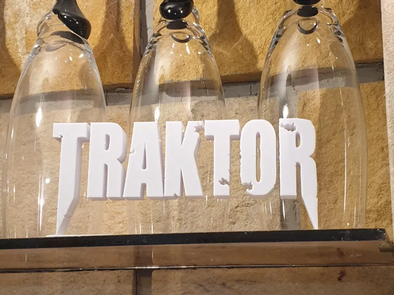 TRAKTOR logo with stand