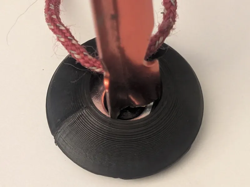 Tent stake pusher with a captive washer