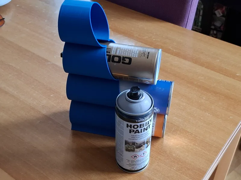 Rack for lying down paint spray cans