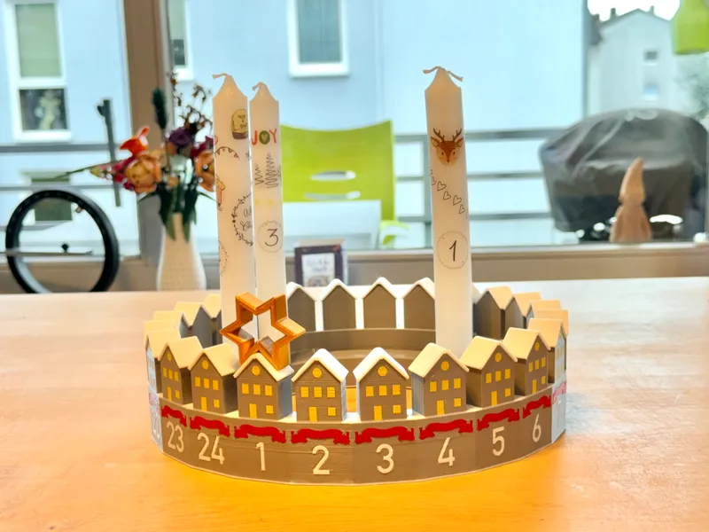 Adventskalender als winterliches Häuser-Ringdorf
