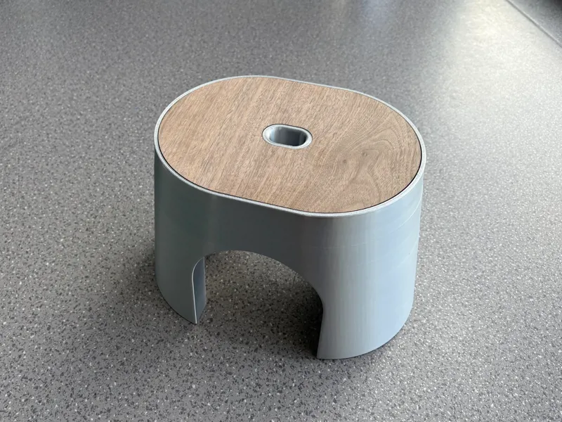 A stool with a wooden surface