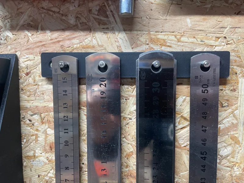 Simple wall-mounted ruler holder