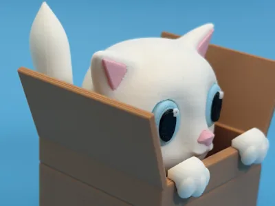 Adorable clicker kitten hidden in a small box.