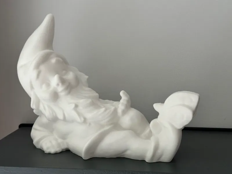 Lying gnome with a butterfly