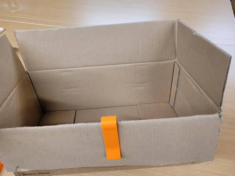 Box flap hold down