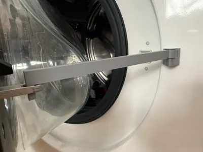 Washing machine door prop magnetic